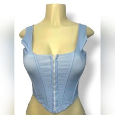 Sexy Cropped Top In Light Blue Denim Color. Sleeveless With A Supportive Shoulder Strap. Square Neckline. Corset Designed Bodice With Hook And Eye Front Closures. Flexible Boning. Regular Stretch. Dress It Up With A Skirt And Heels Or Dress It Down With High Waisted Jeans. Spring Blue Denim Corset, Fitted Denim Blue Sleeveless Tank Top, Blue Stretch Denim Tank Top, Sleeveless Denim Blue Crop Top For Summer, Sleeveless Denim Blue Summer Crop Top, Denim Crop Top For Party, Party Denim Crop Top, Denim Blue Tops For Summer Party, Denim Blue Summer Party Top