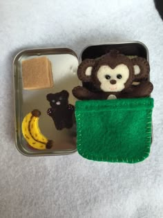 there is a small lunch box with food in it and a monkey on the side