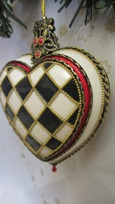 a heart shaped ornament hanging from a christmas tree