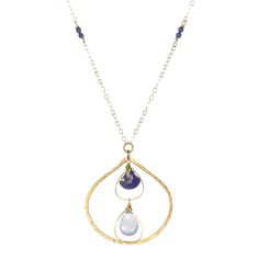 A large shimmering teardrop pendant cradles lapis and natural chalcedony gemstones within, reminiscent of a gentle spring rainfall. Delicate gold-filled wire details add an extra touch of artistry. Shimmering gold chains, adorned with lapis details, complete this show stopping piece. • 14k gold filled • Lapis and natural chalcedony • Pendant Dimensions: about 1.25" • Length: 17" Gold Teardrop Drop Necklace With Natural Stones, Wire Wrapped Teardrop Brass Necklaces, Droplet Necklace, Teardrop Pendant, Jewelry Repair, Gift Jewelry, Ring Bracelet, Semi Precious Gemstones, Earring Necklace