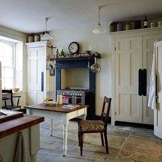 a kitchen with an old fashioned stove and antique furniture in it's center island