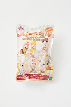 a package of stickers with animals in it on a white surface, next to an orange and pink object