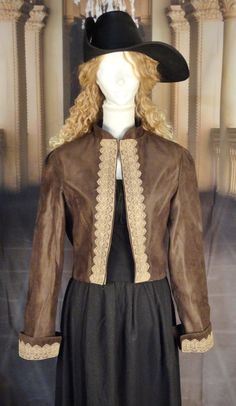 This loose fitting pirate jacket is made of a high quality upholstery faux suede and lined with 100% cotton. Jacket ends slightly below the waist and features a mandarin collar.  Jacket has long sleeves with cuffs trimmed with decorative lace. This jacket is meant to be worn open and features the same decorative lace on both sides down the front.  Finished and ready to ship. Measurements: Bust - up to 40" (approximately); shoulder seam to shoulder seam measured across the back - 15 ½"; back leng Brown Fitted Leather Jacket With Stand Collar, Fitted Brown Outerwear With Suede Overlays, Brown Fitted Gothic Outerwear, Brown Steampunk Outerwear For Winter, Steampunk Brown Winter Outerwear, Brown Steampunk Winter Outerwear, Mandarin Collar Jacket, Pirate Jacket, Bolero Jacket