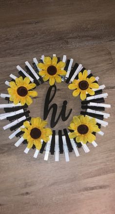 a sunflower wreath with the letter h on it is made out of popsicle sticks