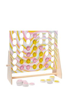 a wooden board game with lots of smiley faces on it and some white circles around the board