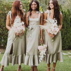 three beautiful women standing next to each other