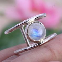 Elevate your style with our stunning Rainbow Moonstone ring. This handcrafted beauty features a mesmerizing Rainbow Moonstone set in a splendid sterling silver ring. *Captivating Colors: The Rainbow Moonstone's iridescent play of colours adds a touch of magic to your look. Each stone is carefully chosen for its unique charm. *Celestial Charm: The sterling silver moonstone setting adds a celestial touch, showcasing the moonstone in an elegant and timeless design. *Handcrafted Beauty: made by skilled artisans, each ring is a work of art that brings a special touch to your style. *Versatile Elegance: Whether for special occasions or everyday wear, this Moonstone ring is a versatile piece that adds a hint of mystique to any outfit. *Perfect Fit: Available in various sizes, ensuring a comfortab Unique Moonstone Open Ring Birthstone, Unique Open Moonstone Birthstone Ring, Handmade Moonstone Open Ring Fine Jewelry, Handmade Open Moonstone Ring In Fine Jewelry Style, Handmade Open Moonstone Ring Fine Jewelry, Unique Stackable Moonstone Rings, Unique Moonstone Open Ring For Anniversary, Unique Stamped 925 Open Moonstone Ring, Unique Stackable Moonstone Ring For Anniversary