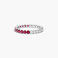 a white gold ring with red and white stones