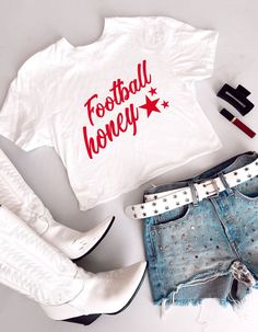 Show your team spirit with our White Cropped T-Shirt, featuring a trendy graphic that says “Football Honey” in bold red lettering. This chic, elegant, boujee, and trendy preppy design is perfect for making a statement on college or professional game days and at tailgate parties. The cropped fit adds a modern, stylish edge, ensuring you stay comfortable and fashionable while cheering on your favorite team. **Key features:**- Chic, elegant, boujee, trendy preppy design- “Football Honey” graphic in bold red lettering- Stylish cropped fit- Soft, comfortable white fabric- Perfect for college and professional game days, and tailgate parties **Keywords:** White Cropped T-Shirt, Football Honey T-Shirt, Trendy Game Day Fashion, Chic Preppy Shirt, Elegant Boujee Style, College Game Day Apparel, Prof Game Day Logo Print T-shirt For Fall, Fall Team Spirit T-shirt With Lettering, Football Season Team Spirit Tops With Lettering, Red T-shirt With Letter Print For Cheerleading, Red Letter Print T-shirt For Cheerleading, Casual Red T-shirt For Cheerleading, Cheerleading Team Name T-shirt For Fall, Fall Cheerleading Team T-shirt, Trendy Letter Print Tops For Cheerleading