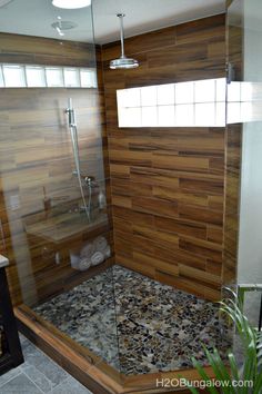 a walk in shower sitting inside of a bathroom