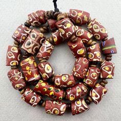 "A strand of mixed brown and white Venetian Beads traded to Africa in the late 1800's or early 1900's. In overall good condition with some chips on a few.  27 beads 19\" strand with wood spacers 10 to 11mm diameter  2mm hole on average" Vintage Style Wooden Beads For Jewelry Making, Artisan Brown Spacer Beads, Brown Polished Beads For Jewelry Making, Brown Beaded Necklace With Colorful Oval Beads, Handmade Artisan Brown Beads, Handmade Brown Artisan Beads, Vintage Brown Beaded Necklaces With Colorful Beads, Traditional Brown Hand-strung Beaded Necklaces, Traditional Brown Beaded Necklace Hand-strung