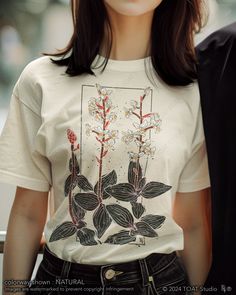 Indulge your passion for orchids with our exquisite Jewel Orchid Blockprint t-shirt design, crafted to capture the delicate beauty of these rare blooms in vibrant detail. Perfect for plant enthusiasts and nature lovers alike, this shirt blends artistic elegance with botanical charm, making it a must-have addition to your wardrobe. Embrace the allure of orchids wherever you go and showcase your love for these stunning plants with every wear. FABRIC CONTENT:  - Fabric content varies based on color Botanical Plants Print Relaxed Fit T-shirt, Botanical Plants Print T-shirt With Relaxed Fit, Botanical Relax Fit T-shirt With Plant Print, Botanical Relaxed Fit T-shirt With Plant Print, Botanical Screen Print Short Sleeve T-shirt, White Botanical Screen Print Tops, Botanical Flower Graphic Print T-shirt, Botanical Style Flower Graphic T-shirt, White Botanical Graphic Print T-shirt