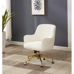 a white office chair sitting on top of a wooden floor next to a potted plant