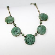 Incredible 1920s era 14k & 18k yellow gold jadeite jade necklace! This rare piece of fine Art Deco era jewelry features 5 carved floral jade gemstones, which are securely prong set. The necklace also contains 8 pretty beads and intricate filigree links. The necklace secures with a spring ring. Gorgeous fine genuine green gemstone necklace! This piece comes with a complimentary Qualitative Report by a GIA Graduate Gemologist. *Sale - price reduced from $2250 USD to $2150 USD.  ERA - Circa 1920s - 1920s Necklace, Green Gemstone Necklace, Filigree Jewelry, Pretty Beads, Logo Gifts, Jade Necklace, 1920s Art Deco, Yellow Gold Setting, Wedding Jewellery Necklace