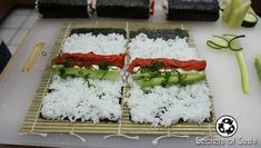 sushi with cucumbers and tomatoes on a bamboo mat