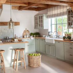 a kitchen filled with lots of counter top space and wooden stools next to a sink