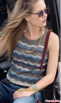 a woman sitting in the passenger seat of a car with her hair blowing in the wind