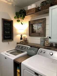 a washer and dryer sitting next to each other in a room with white walls