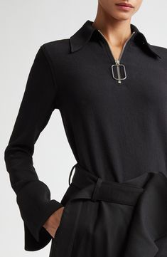 An Anderson mash-up of sporty and sophisticated, this quarter-zip pullover pulls out the fashion stops with a prim point collar and flared, split cuffs. A bent-wire version of the brand's signature zipper pull accessories the style. 23 1/2" length (size 8) Quarter-zip closure Point collar Long sleeves with split cuffs 100% polyester Dry clean Imported Designer Clothing Half-zip Fall Workwear Top, Fall Workwear Tops With Half-zip, Half-zip Top For Workwear In Fall, Half-zip Top For Fall Workwear, Modern Tops For Workwear, Modern Half-zip Tops For Fall, Fleece Quarter Zip, Jw Anderson, Running Tops