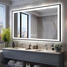 a bathroom vanity with two sinks and a large mirror above it, in front of a window