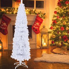 a white christmas tree with stockings hanging from it's sides in front of a fireplace