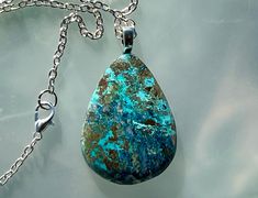 A beautiful and rare Shattuckite necklace on a 18 inch  steel necklace.  I sliced the stone and hand shaped and polished it using lapidary equipment. My wife, who has smaller hands then me, then strung it on the chain. Each pendent is a unique, one of a kind creation and you will not find another one just like it. Metaphysically, Shattuckite is believed to promote clarity of mind, heart, and throat. It helps in communicating truths, helping you to speak clearly and honestly from the heart. Blue Chrysocolla Necklace With Large Stone, Blue Teardrop Necklace With Large Stone, Oval Chrysocolla Necklaces As Gifts, Untreated Teardrop Pendant Necklace As A Gift, Untreated Teardrop Pendant Necklace For Gifts, Oval Chrysocolla Necklace As A Gift, Oval Chrysocolla Necklace Gift, Chrysocolla Oval Pendant Necklace As Gift, Chrysocolla Oval Pendant Necklace For Gifts