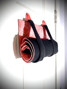 two handbags hanging on the wall next to each other