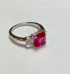 Celebrate her July birthday with this timeless fashion ring. This minimalist-chic ring for her features a cushion lab-created ruby and shimmering round two(.01ctw) Diamonds. Center Stone: 8mm Cushion Lab Created Ruby Side Stones: .01ctw Round Diamond Please visit our store for more jewelry https://www.etsy.com/shop/ritapierredesigns SHIP TIME: Orders Ship Free via USPS First Class All orders can be upgraded to priority for an additional fee. RETURNS: We want you to be completely happy with your Anniversary Lab-created Ruby Cushion Cut Jewelry, Luxury Sterling Silver Ruby Ring With Brilliant Cut, Luxury Diamond-cut Ruby Ring Gift, Silver Diamond-cut Ruby Ring For A Gift, Exquisite Brilliant-cut Ruby And Diamond Ring, Ruby Diamond Ring, Chic Rings, Ruby Birthstone, Ring Ruby