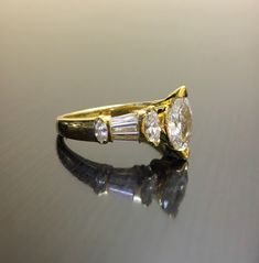 a gold ring with three diamonds on it