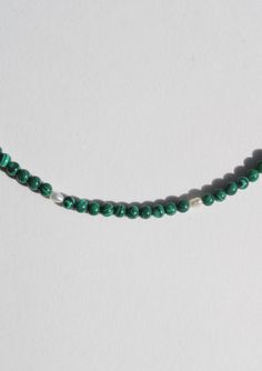 Another addition to our coveted strands of beads. A string of tiny malachite beads, seed pearls and finished with a 14 karat gold ball clasp. Measures 16" long