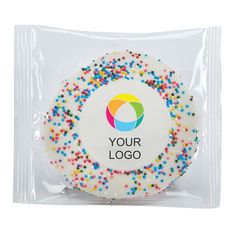 a white frosted cookie with sprinkles in the shape of a circle