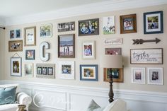 a living room wall filled with lots of pictures and framed photos on it's walls