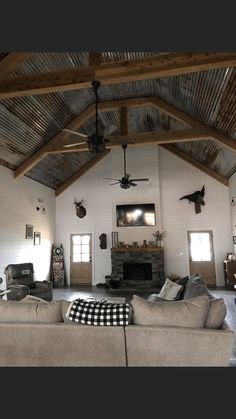 a living room filled with furniture and a ceiling fan