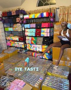 a woman sitting on top of boxes in a store