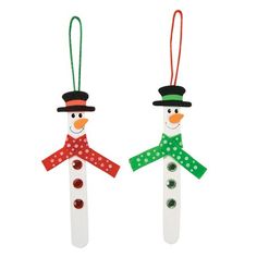 two snowmen made out of toothpicks with green and red ribbons on them