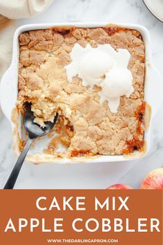 an apple cobbler in a white dish topped with ice cream