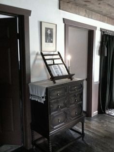 an antique dresser in the corner of a room