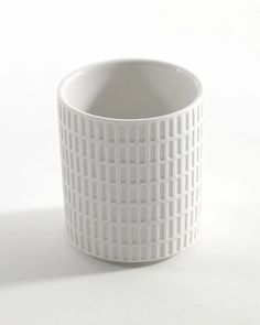 a white cup sitting on top of a table