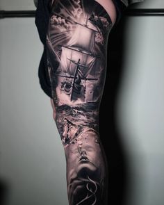 a man's arm with an image of a ship on it