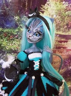 a doll with blue hair wearing a black and white dress