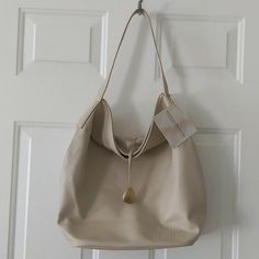 New, With Tags, True Color Is An Ivory/Beige Not Tan. Very Clean Inside And Outside. This Is Weekend Or Beach Tote/Shoulder Bag, It Has A Lot Of Room Inside It Has Snap Closure . Measurements: Photographed, See Pictures Everyday Cream Hobo Shoulder Bag, Cream Hobo Shoulder Bag For Everyday, Chic Neutral Hobo Bag For Daily Use, Casual Cream Hobo Bag For Shopping, Chic Beige Hobo Bag For Everyday, Versatile Cream Hobo Bag For Shopping, Chic Cream Hobo Bag For Shopping, Chic Cream Hobo Bag With Large Capacity, Chic Cream Hobo Bag For Travel