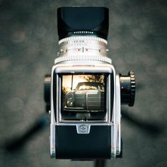 a close up of a camera with a car on it