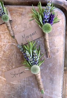 three boutonnieres with succulents on them