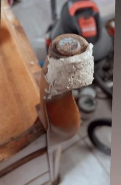 a piece of cake sitting on top of a wooden cutting board next to other tools