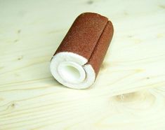 a roll of toilet paper sitting on top of a wooden table