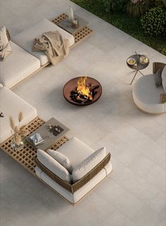 an aerial view of a patio with furniture and fire pit