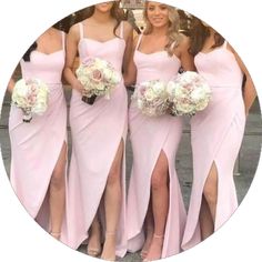 four bridesmaids in pink dresses posing for the camera with their bouquets on