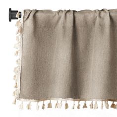 a curtain with tassels hanging from it's side