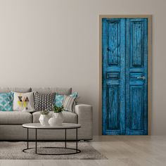 a living room with a couch, coffee table and blue door