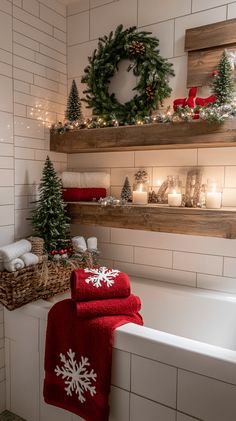 a bathroom decorated for christmas with candles and wreaths on the shelf above the bathtub